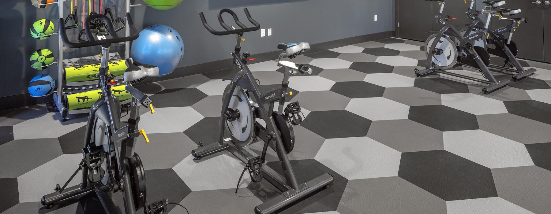 a room with bikes and medicine balls